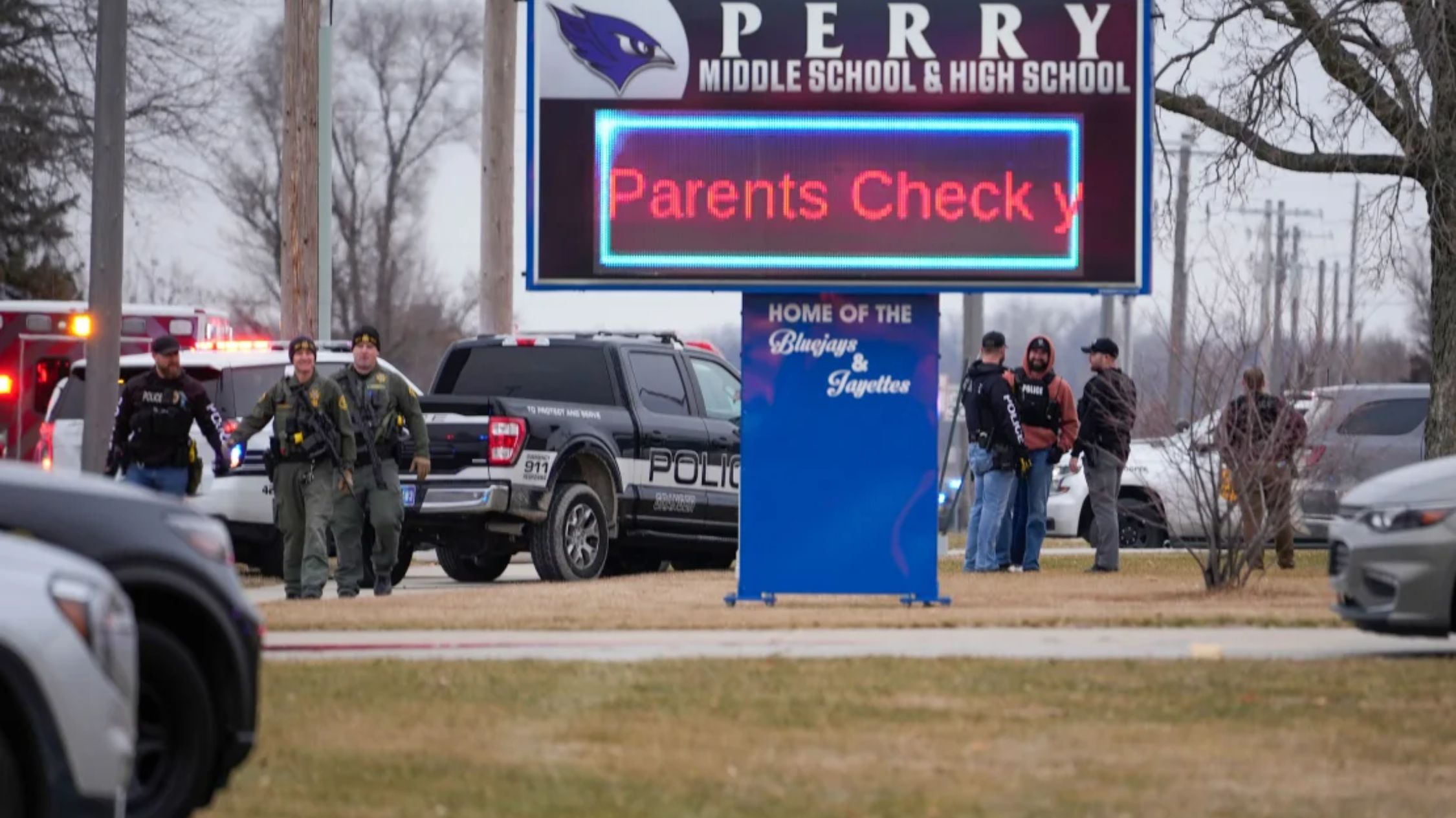 There were law enforcement officers outside Perry High School.  (Photo credit: Andrew Harnick/AP)