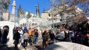 La gente se reúne frente a un edificio destruido en un ataque israelí en Damasco, Siria, el sábado. (Louai Beshara/AFP/Getty Images)