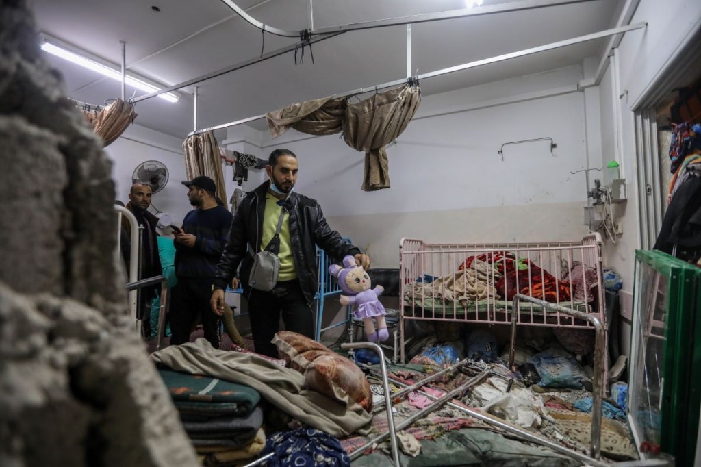 People inspect damage caused by an artillery shell that hit the maternity hospital inside the Nasser Medical Complex, on December 17, 2023, in Khan Yunis, Gaza.  (Photo by Ahmed Hasballah/Getty Images)
