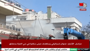 Imagen de la televisión estatal siria muestra el edificio de varios pisos alcanzado por el ataque israelí en Damasco.