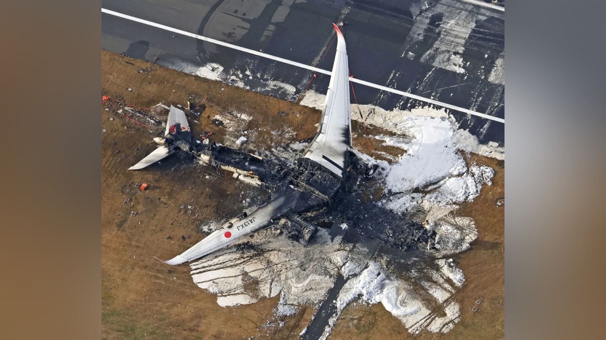 A Japan Airlines plane burns at Haneda Airport in Tokyo, Japan this Wednesday.  (Credit: Kyodo News/AP)