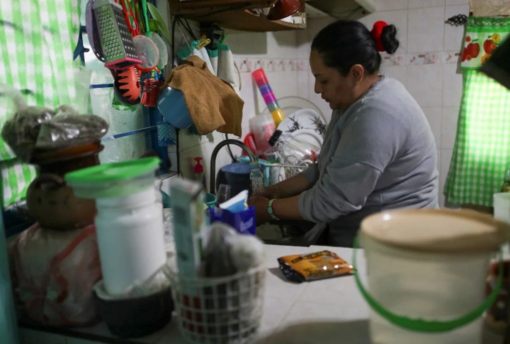 Una mujer lava los platos en su casa luego de recibir una distribución gratuita de agua en el barrio Iztapalapa el 31 de enero de 2024. (Foto: Henry Romero/Reuters).