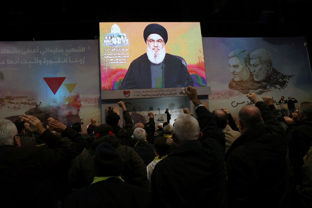 La gente ve el discurso televisado del jefe de Hezbollah del Líbano, Hassan Nasrallah, el 3 de enero. (Foto: Anwar Amro/AFP/Getty Images).