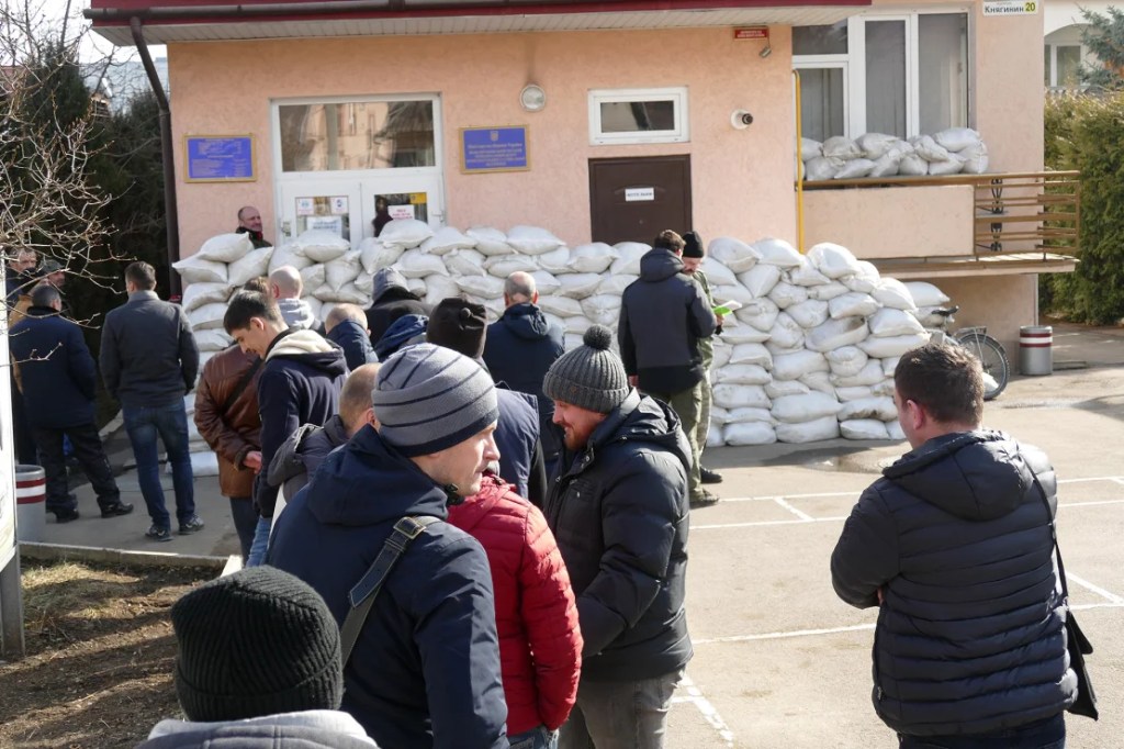 Voluntarios, fotografiados el 25 de febrero de 2022, hacen fila frente a la oficina de registro y alistamiento militar de la ciudad para unirse a la Fuerza de Defensa Territorial, Ivano-Frankivsk, en el oeste de Ucrania. (Foto: Yurii Rylchuk/Ukrinform/Future Publishing/Getty Images).