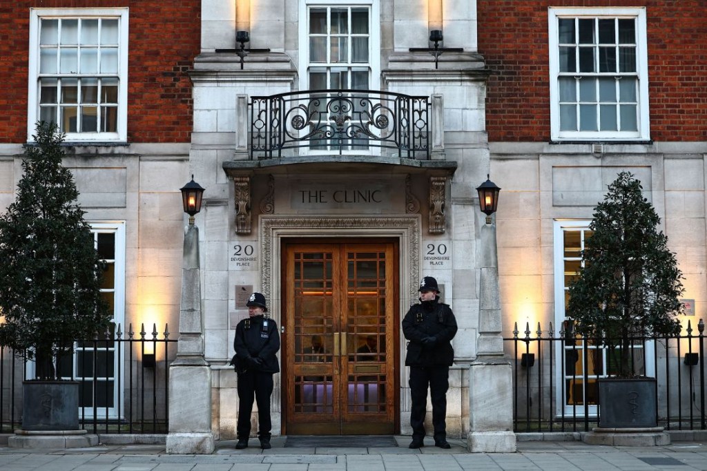 Police officers stand guard outside the London clinic where Kate had surgery in January.  (Credit: Henry Nicholls/AFP/Getty Images)