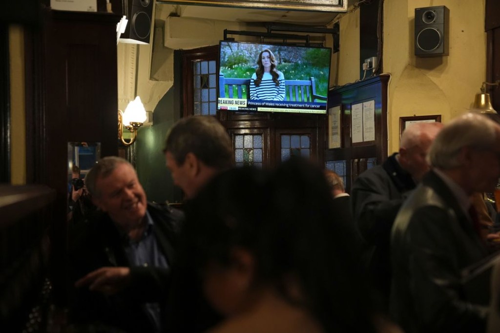 The announcement of Kate's cancer was televised in Britain.  The picture is of a pub in London on March 22, 2024.  (Credit: Aaron Chown/Press Association/AP)