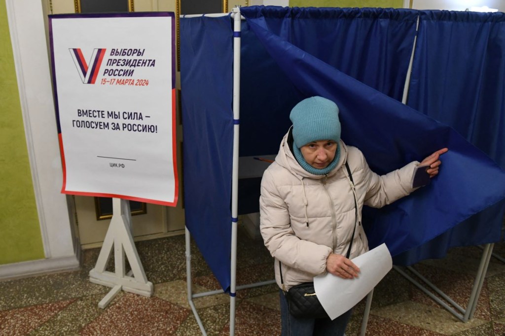 A woman casts her vote in Russia's presidential election at a polling station in Donetsk, Russian-controlled Ukraine, on March 16, 2024, amid the Russia-Ukraine conflict.  (Photo by STRINGER/AFP via Getty Images)