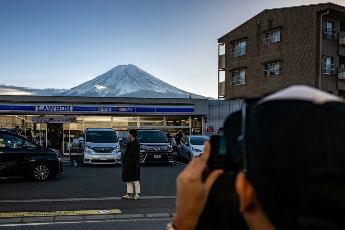 A Japanese town raises a barrier to prevent tourists from taking selfies on Mount Fuji