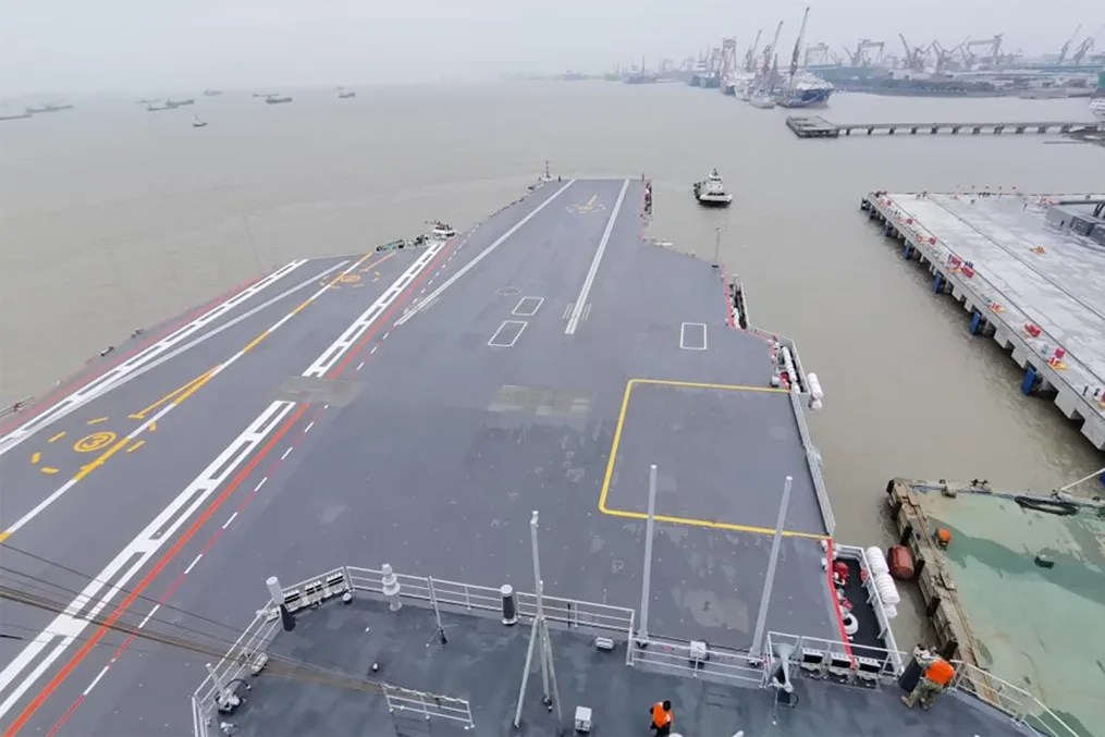 A tugboat tows China's third aircraft carrier Fujian away from a dock in Shanghai, east China, on May 1, 2024.  Li Tang/Xinhua