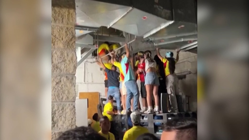 Aficionados trepan por conductos de ventilación para entrar en el estadio de fútbol de la final de la Copa América
