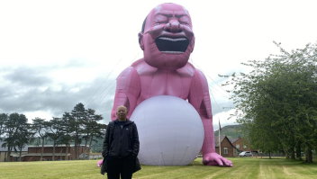 Yue Minjun frente a su instalación de arte inflable (Escuela de Ruthin)