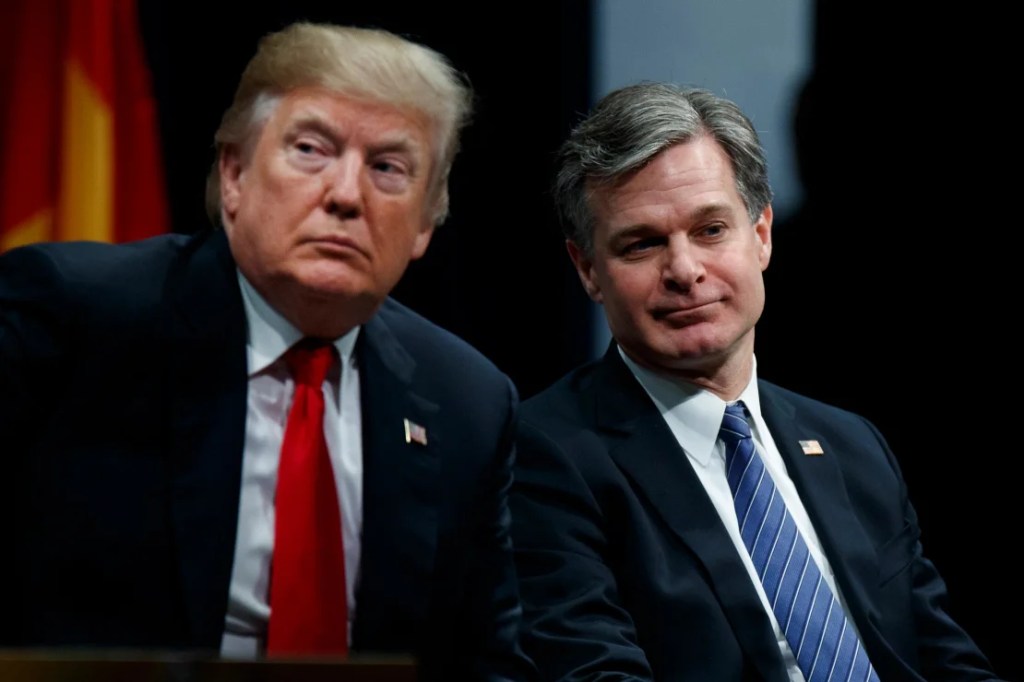 En esta foto de 2017, el entonces presidente Donald Trump se sienta con el director del FBI Christopher Wray en Quantico, Virginia. (Evan Vucci/AP/Archivo)